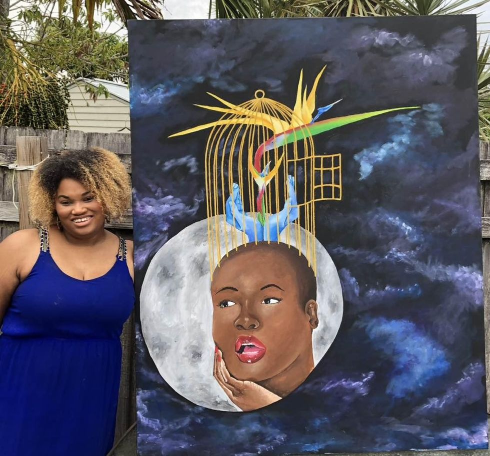 Stephanie Gowdy with one of her paintings.