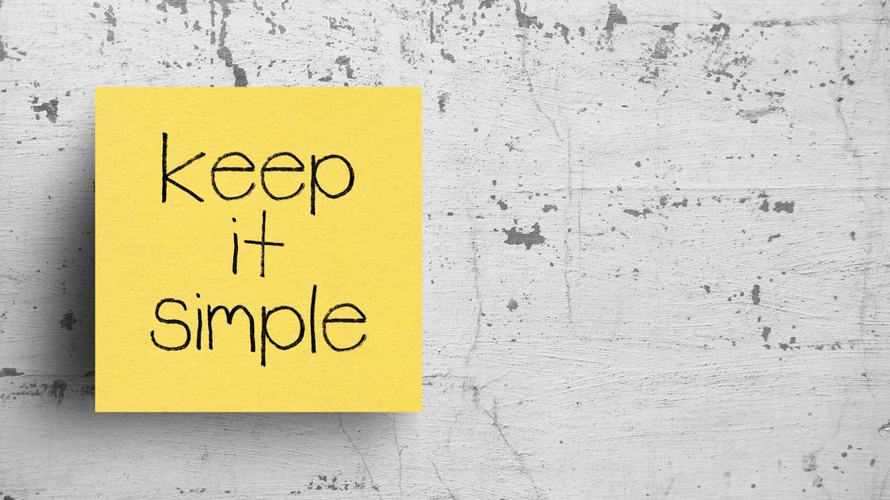Sticky note on concrete wall, that says Keep it simple
