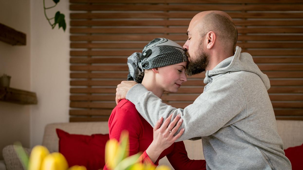 Supportive husband kissing his wife, cancer patient
