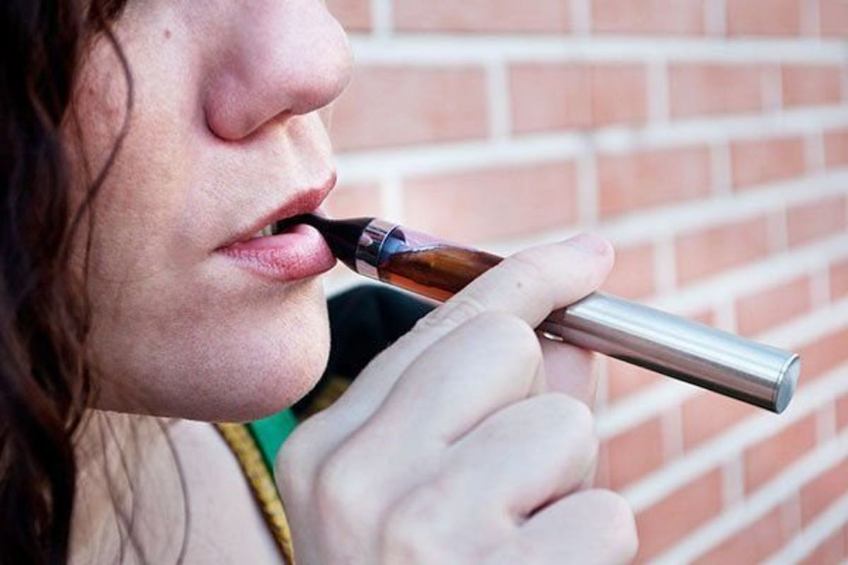 teen girl smoking an e-cigarette