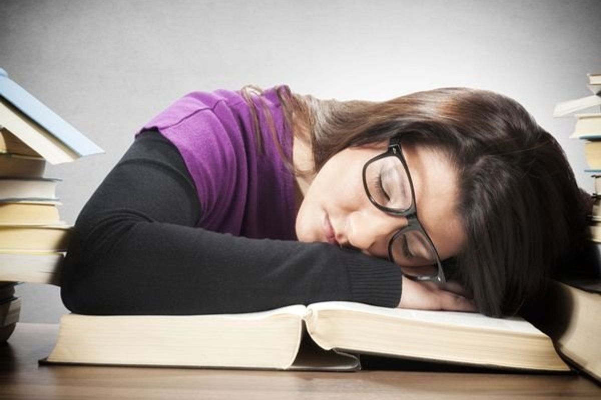 teen sleeping on a book