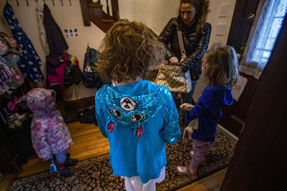 The family gathers in the entranceway of their house before heading out to the playground.