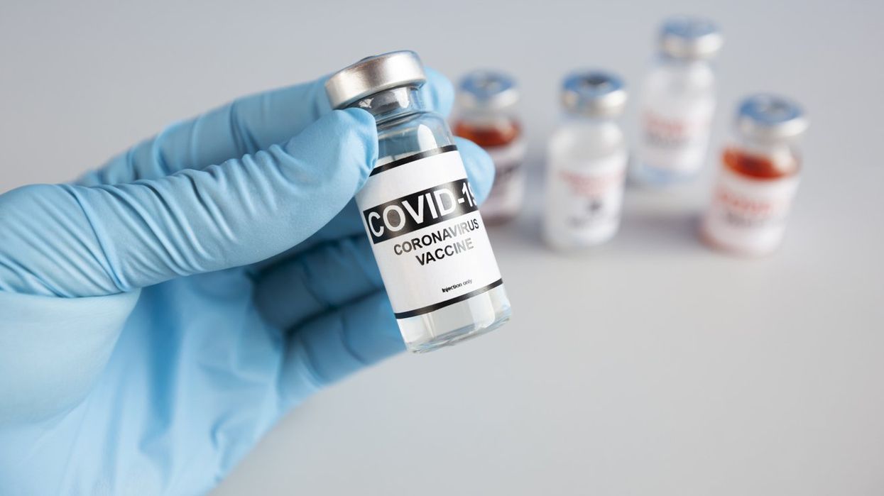The nurse holding one form five types of covid 19 vaccines in hand