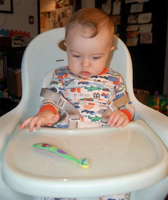 toddler holding a toothbrush