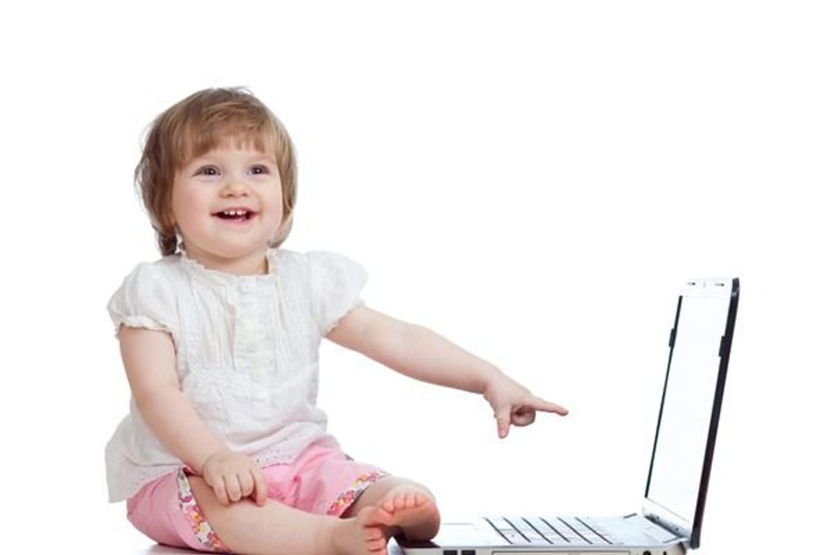toddler pointing at a laptop