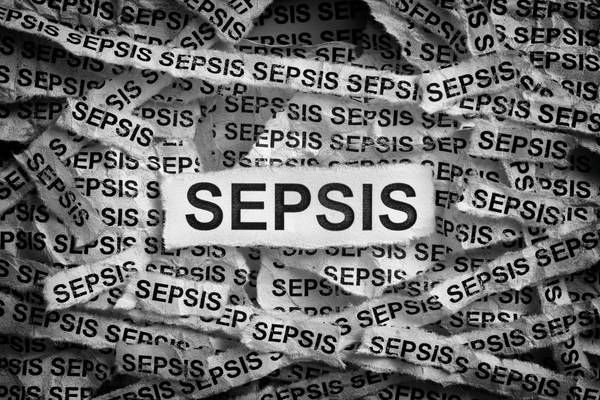Torn pieces of paper with the word Sepsis
