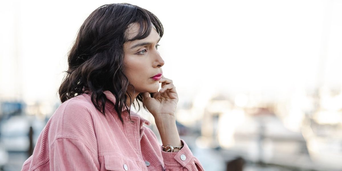 Transgender person contemplating and looking at the view