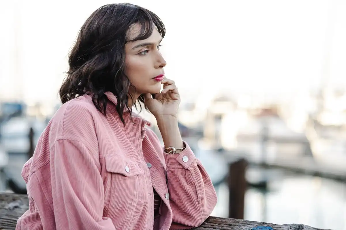 Transgender person contemplating and looking at the view