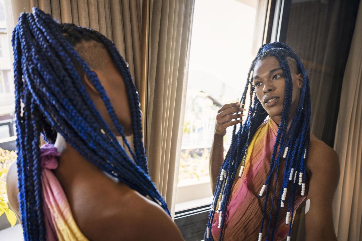 transgender woman looking in the mirror