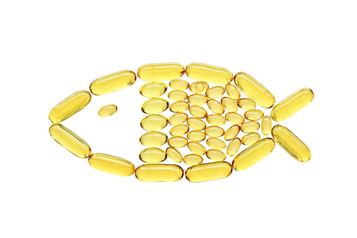 Transparent yellow medical capsules in fish shape