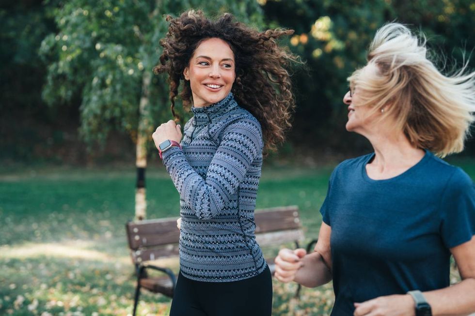 Two female friends jogging in the park