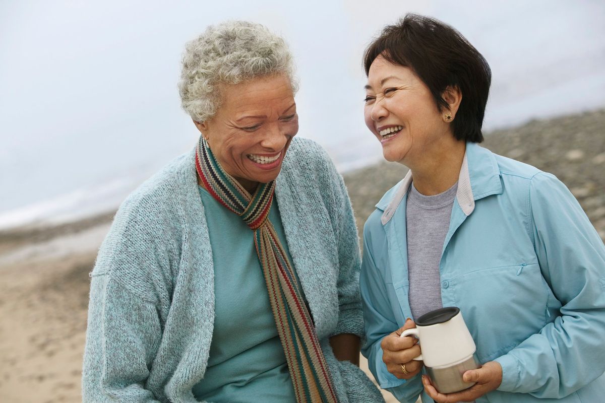 Two Friends Talking over Coffee on the Beach