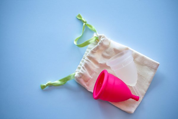 Two Menstrual cups of different sizes and colours