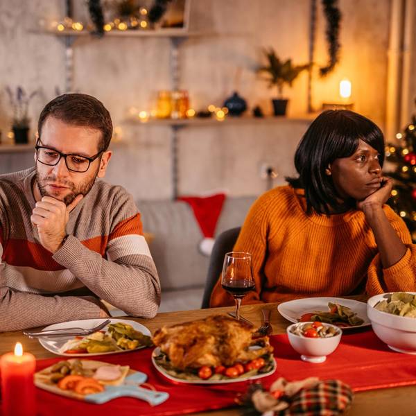 Unhappy couple ignoring each other at Christmas dinner