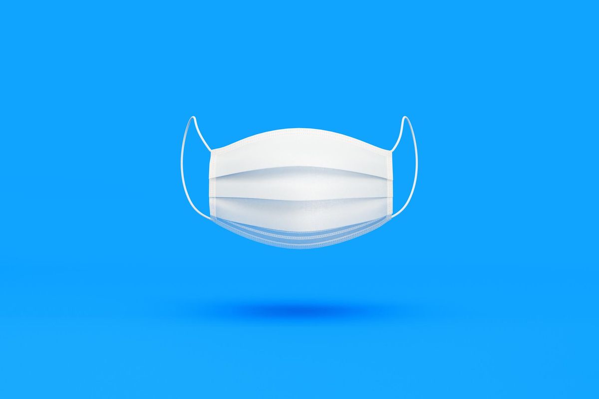 White Protective Mask over Blue Background