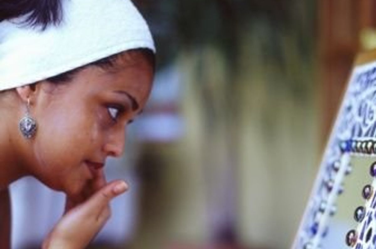 woman applying eye moisturizer