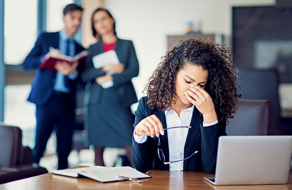 woman at work with a migraine