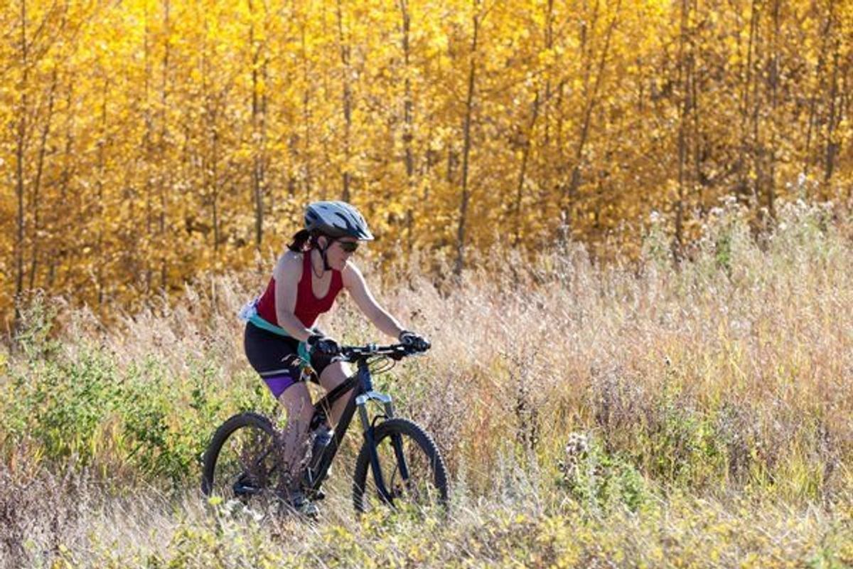woman biking in a field