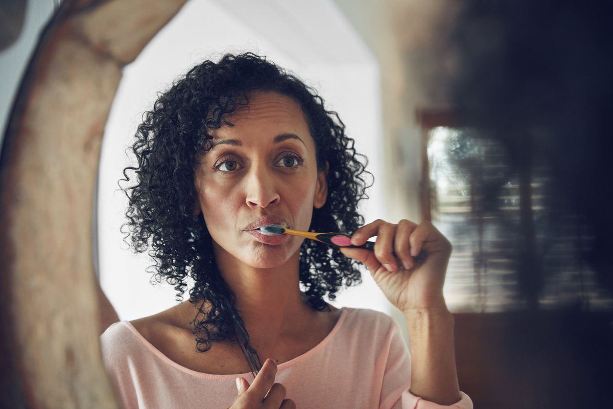 woman brushing her teeth