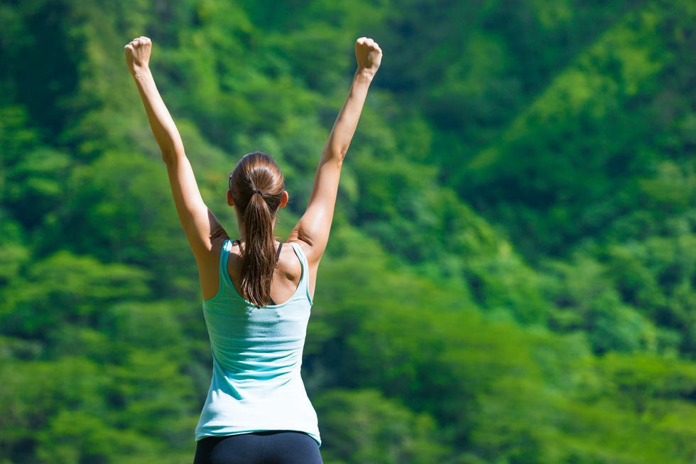 Woman celebrating her achieved goals.