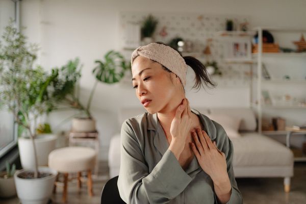 woman checking head and neck cancer symptoms