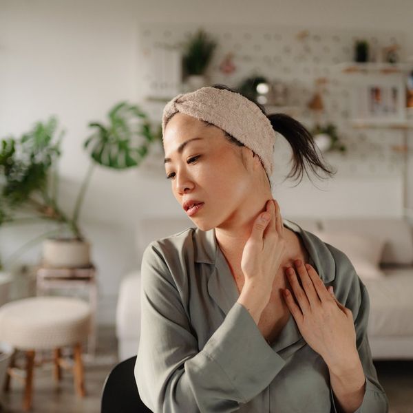 woman checking head and neck cancer symptoms