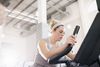 woman doing a High-Intensity Workout on an exercise bike in a gym