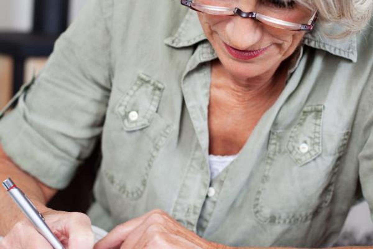 woman doing crossword puzzle