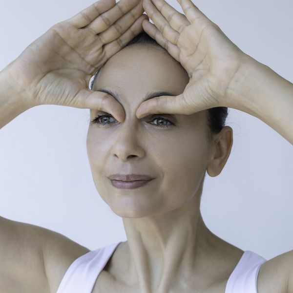 woman doing face yoga