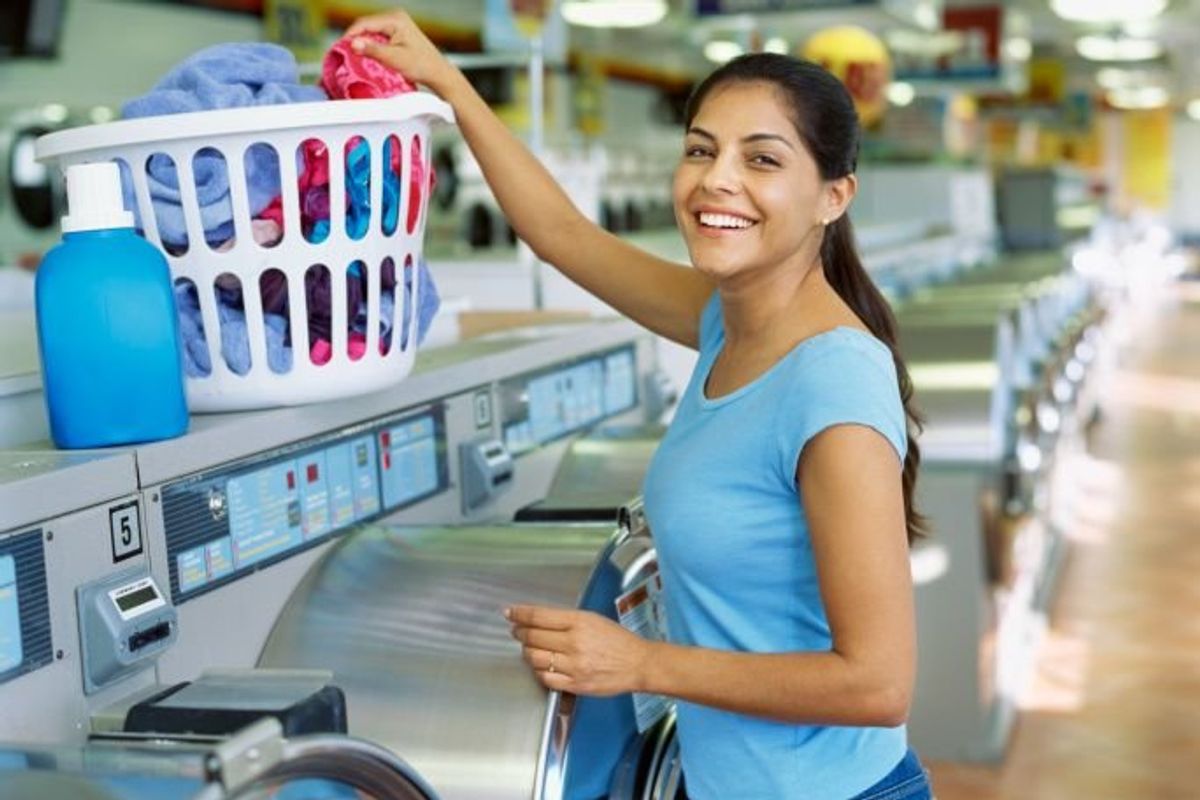 woman doing laundry at a laundromat