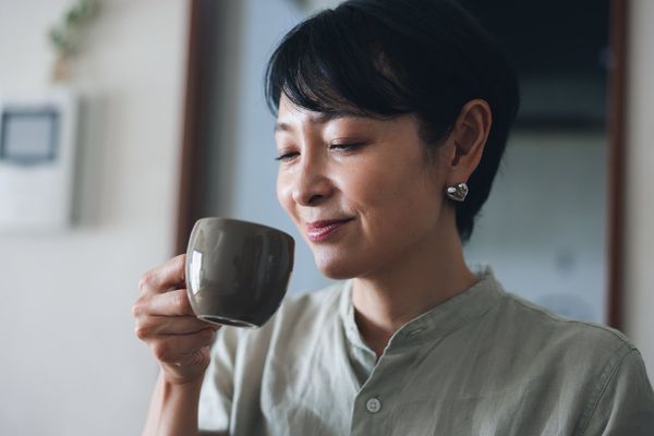 Woman Drinking a Cup of Coffee at Home