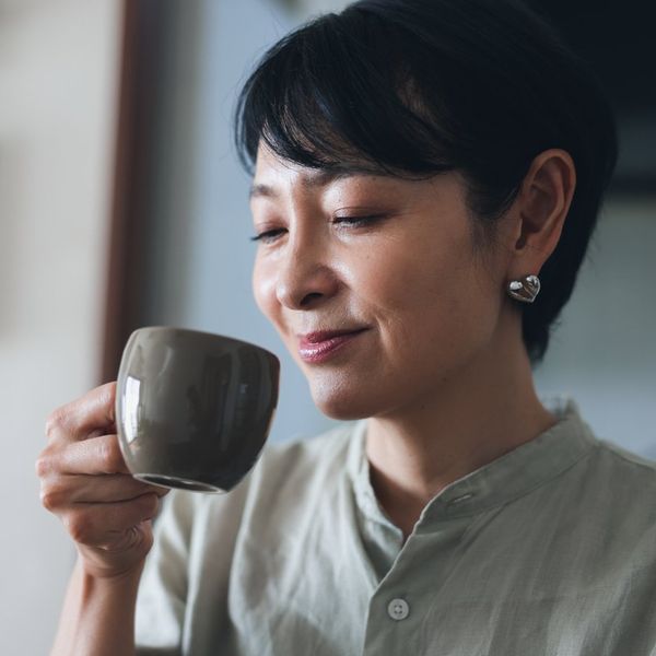 Woman Drinking a Cup of Coffee at Home