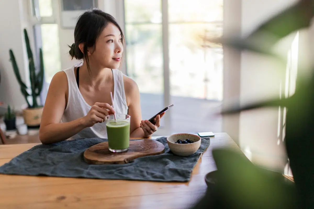 woman drinking a smoothie