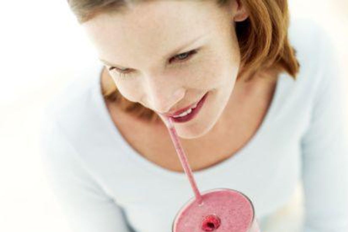 woman drinking a smoothie