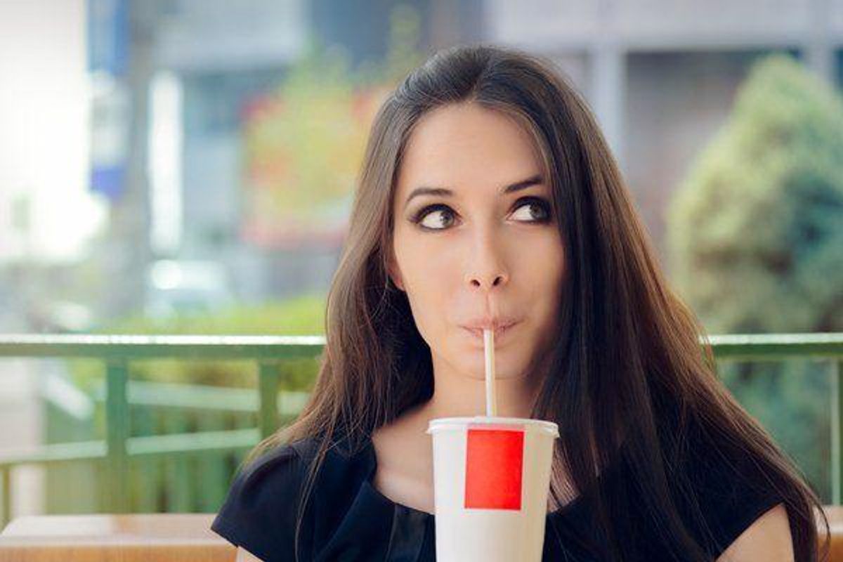 woman drinking a soda