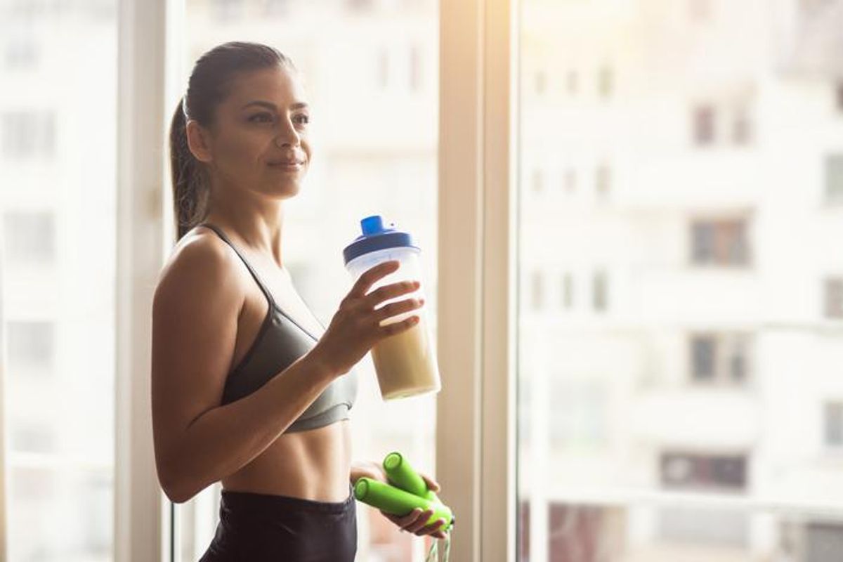 woman drinking before a workout