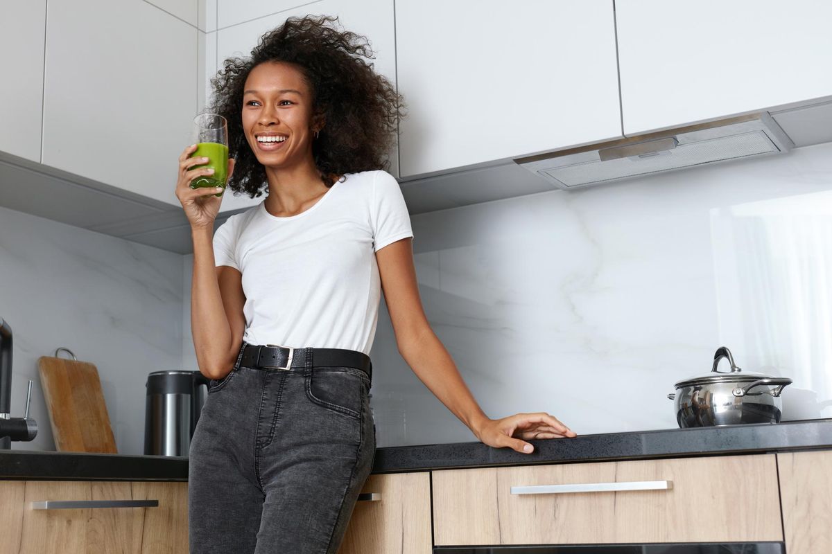 Woman drinking green detox juice, smoothie drink