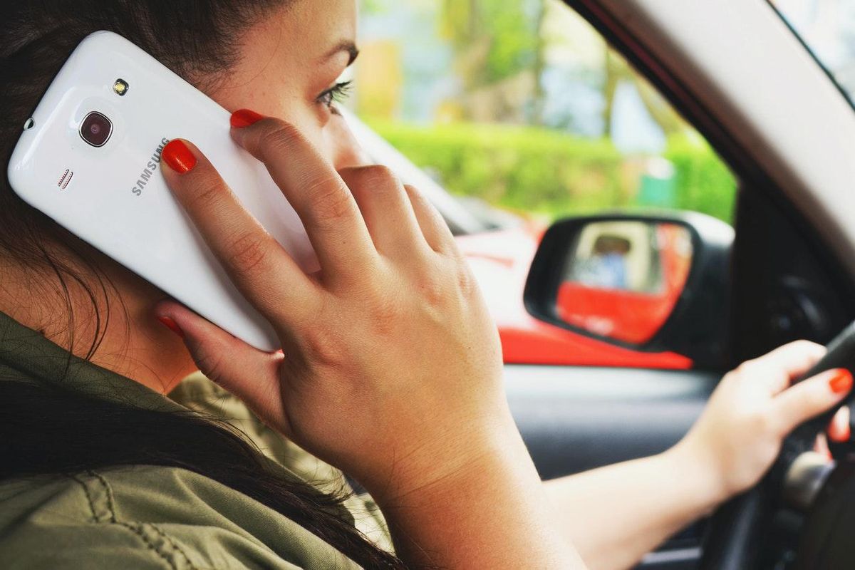 woman driving and talking on the phone
