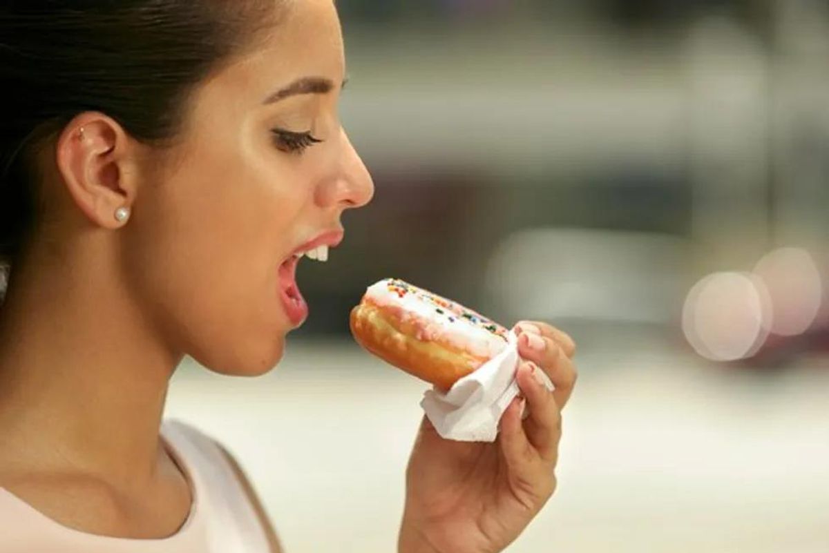 woman eating a donut