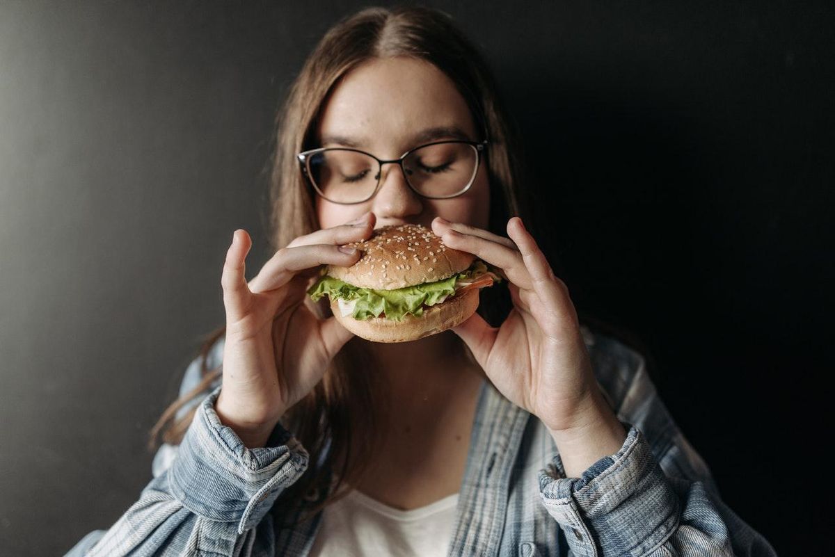 woman eating a hamburger