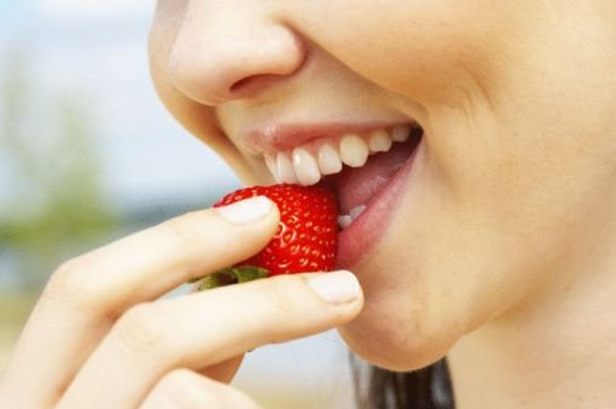 woman eating a strawberry
