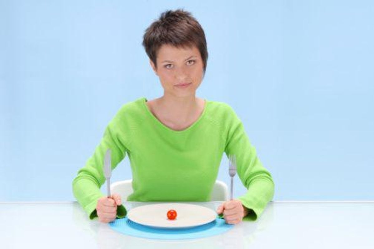 woman eating a tomato