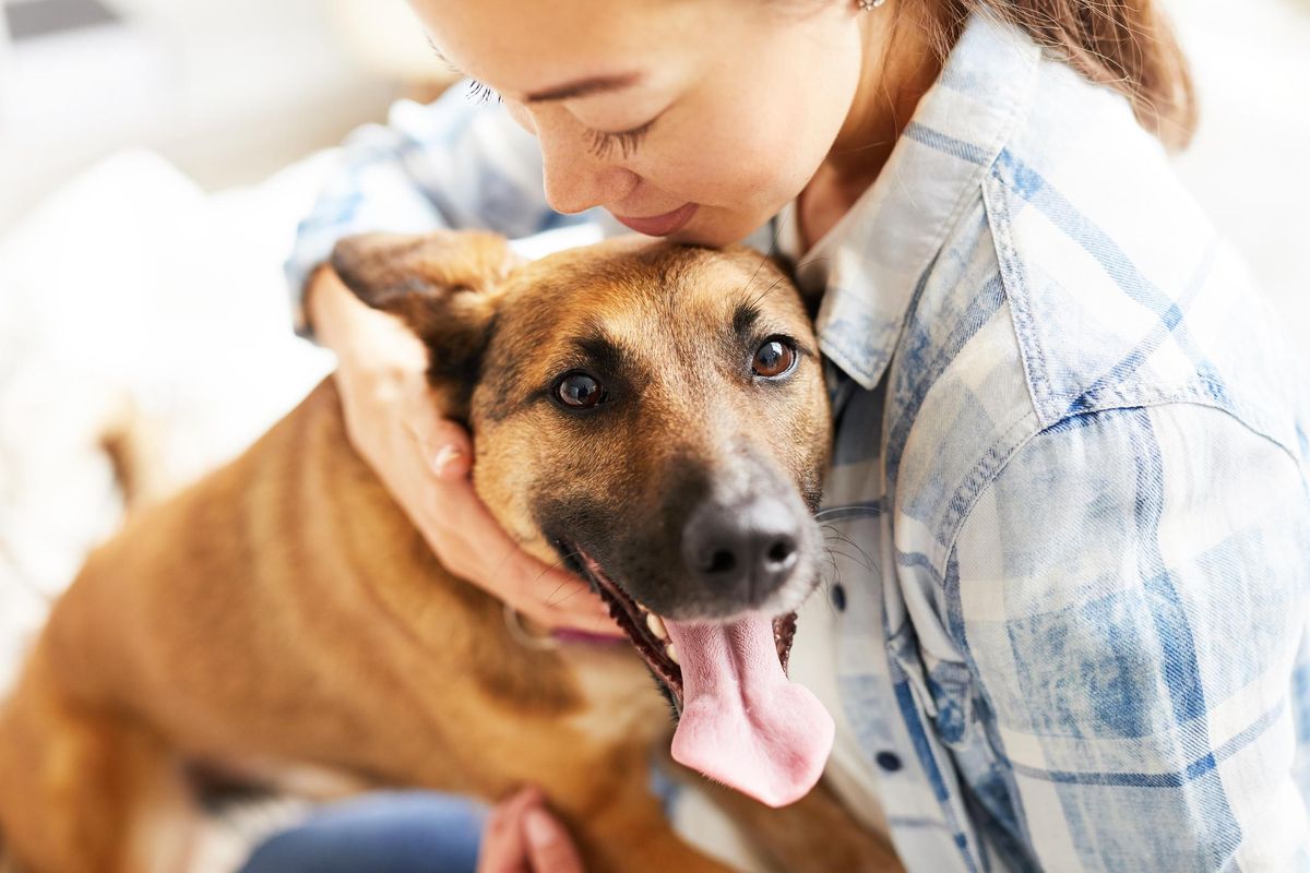 Woman Embracing Dog