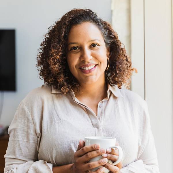 woman enjoys cup of coffee in morning
