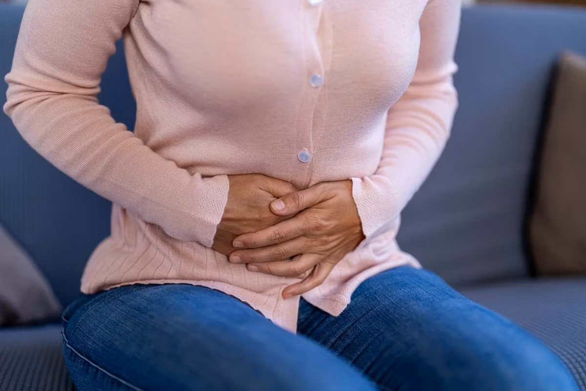 Woman experiencing stomach pain
