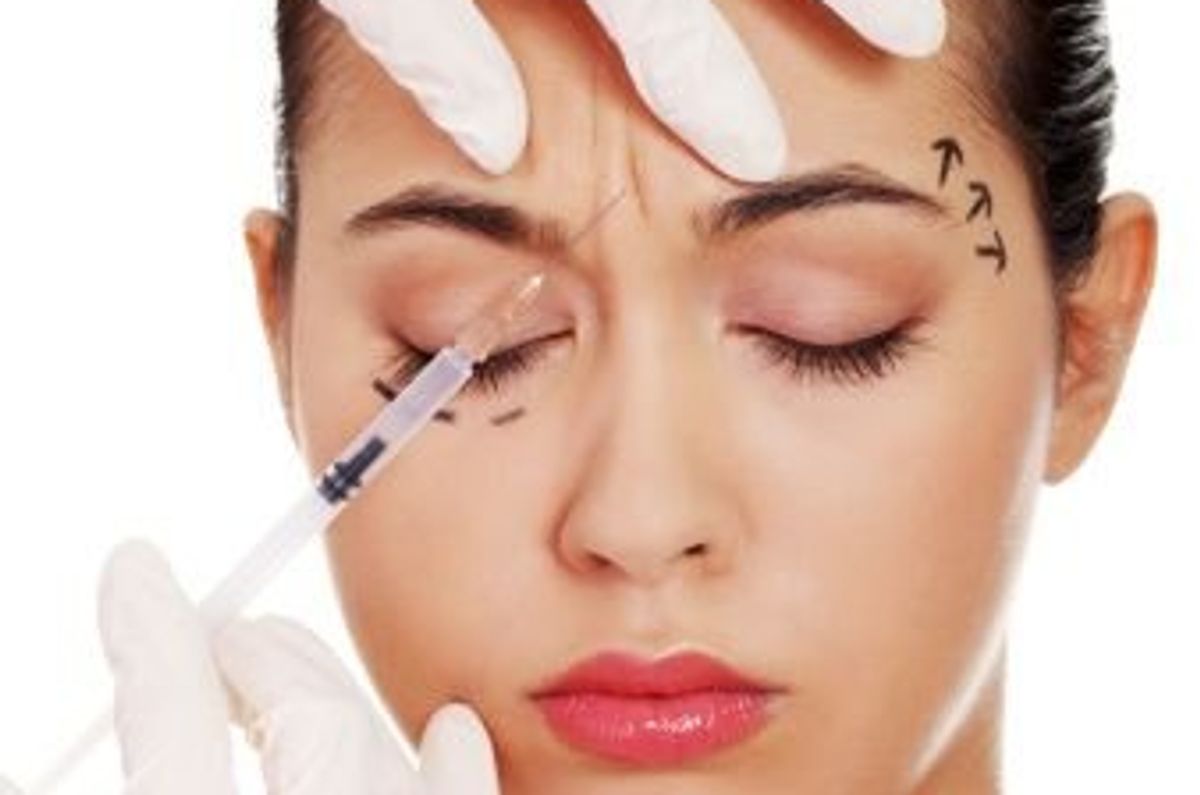 woman getting botox injected into her eyebrow area