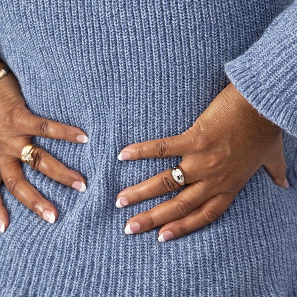 woman grabs lower back in pain