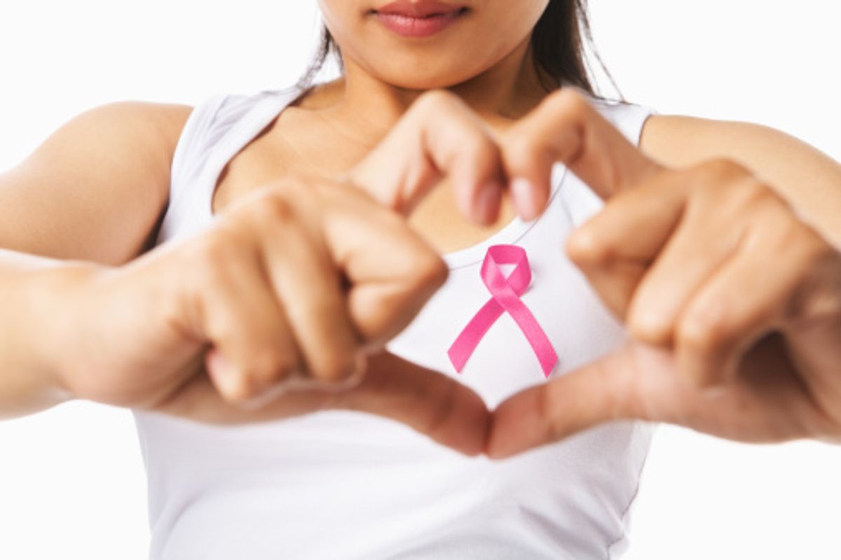 woman holding a breast cancer awareness ribbon