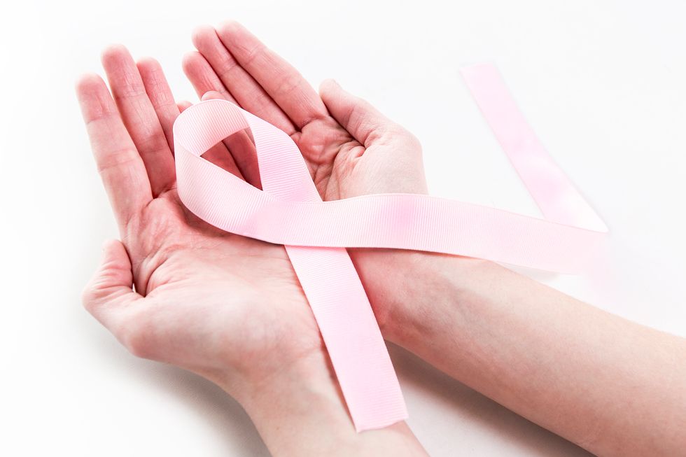 woman holding a breast cancer ribbon