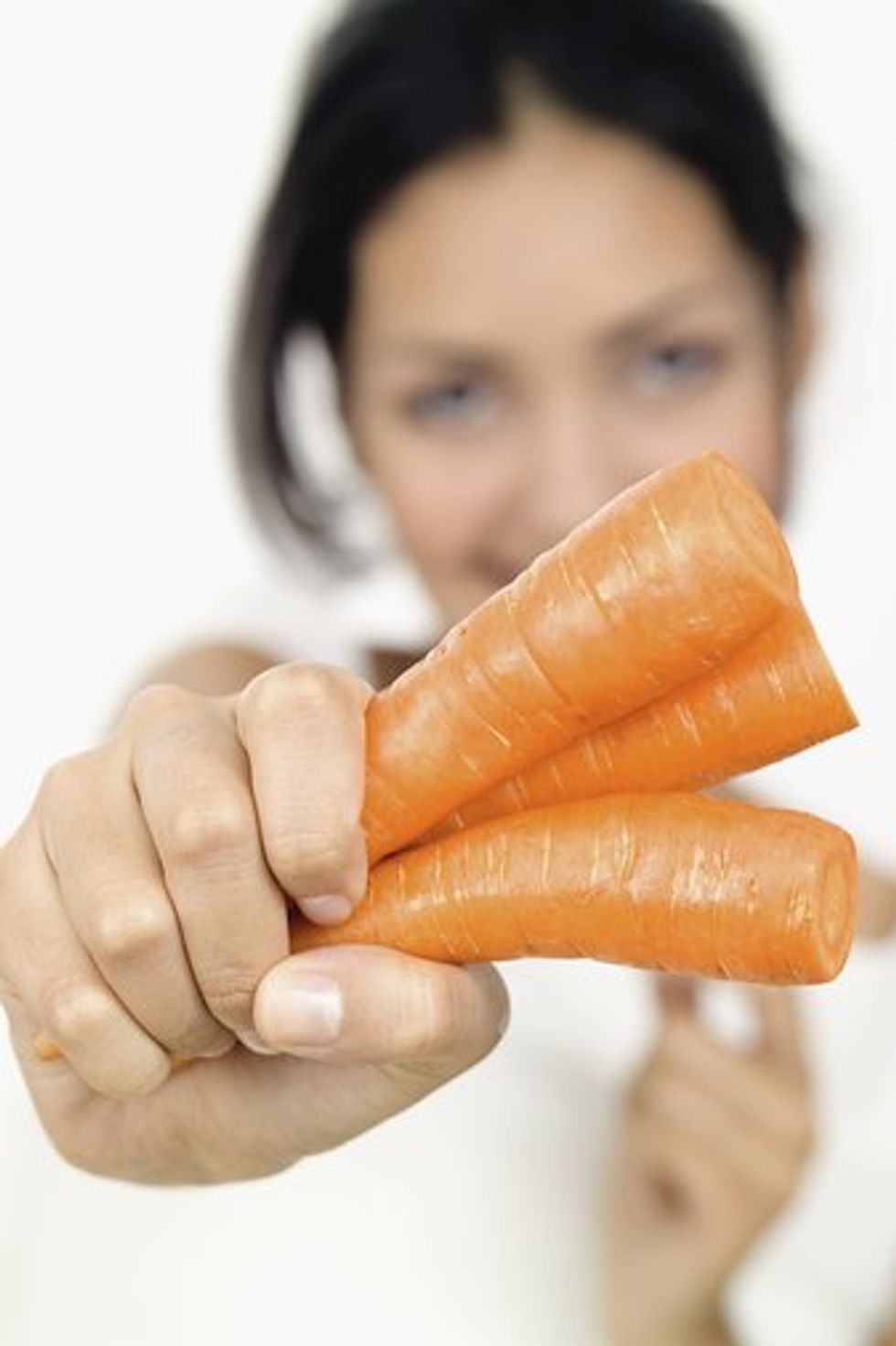 woman holding a carrot